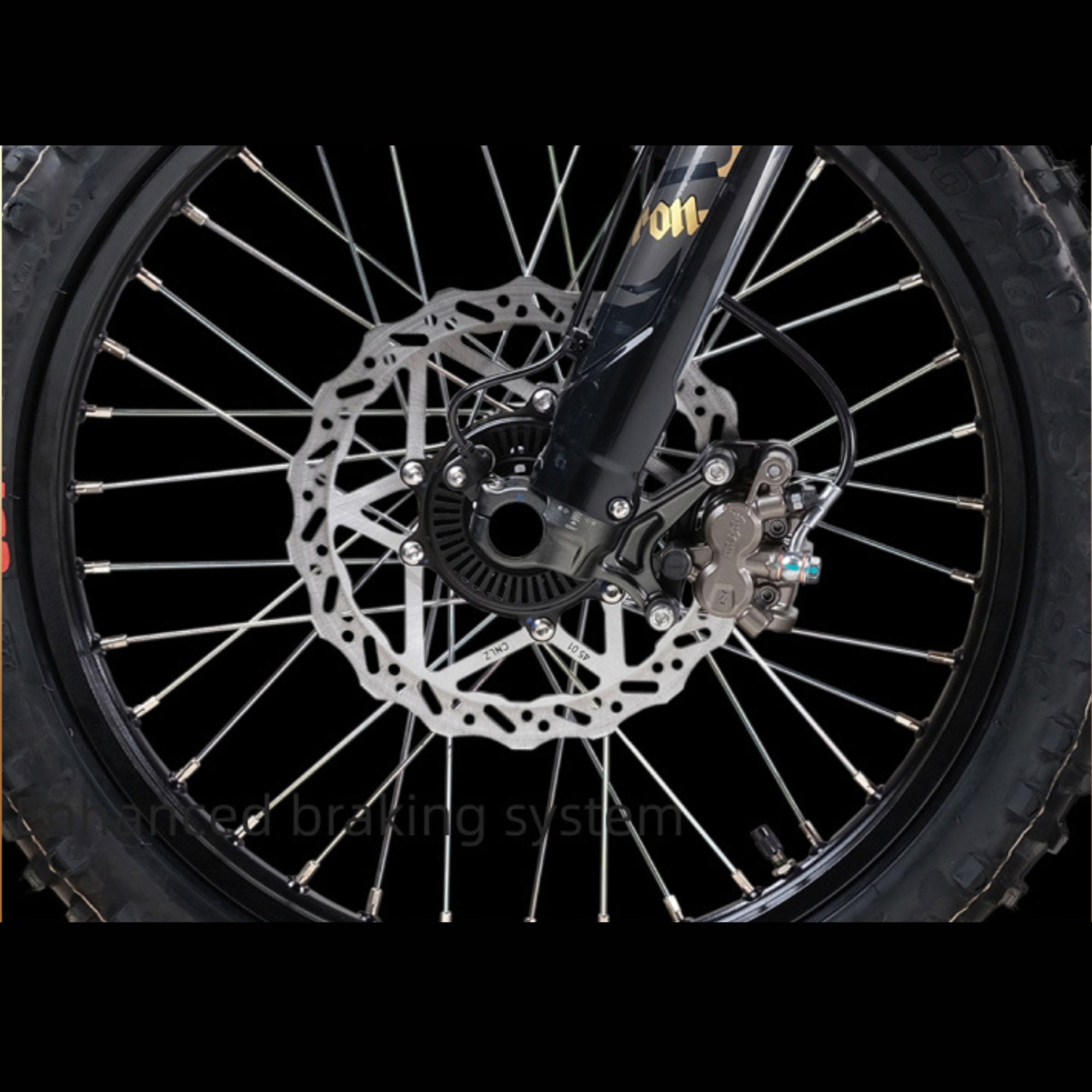 Close-up of a motorcycle wheel with disc brake system on a black background