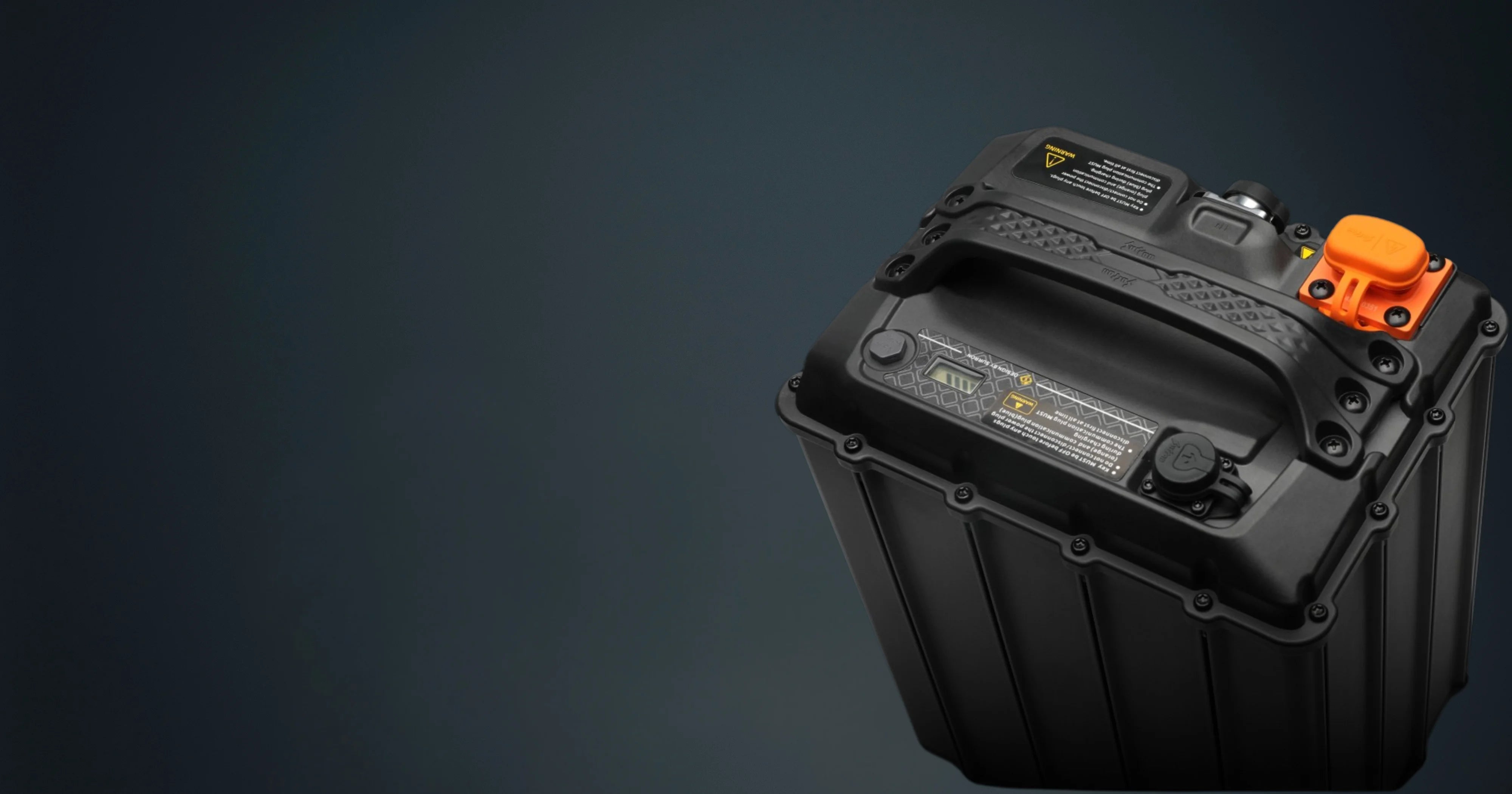 Black battery with orange terminal on a dark gray background
