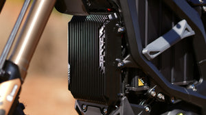 Close-up of surron ultrabee motorcycle engine with 'KTM' branding on a blurred background