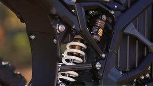 Close-up of a motorcycle suspension system with a blurred background