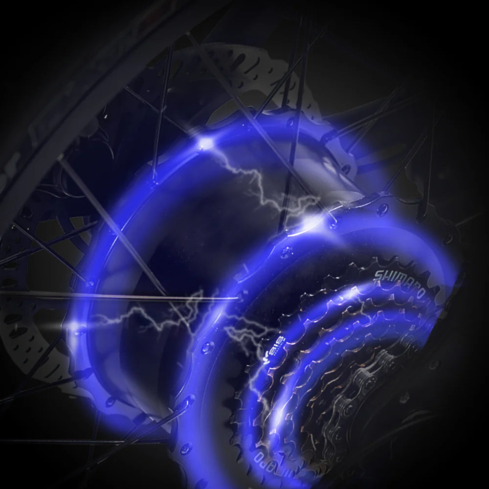 Bicycle wheel with glowing blue light effects on a dark background
