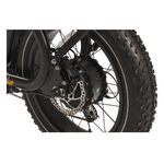 Close-up of a motorcycle wheel with disc brake on a white background