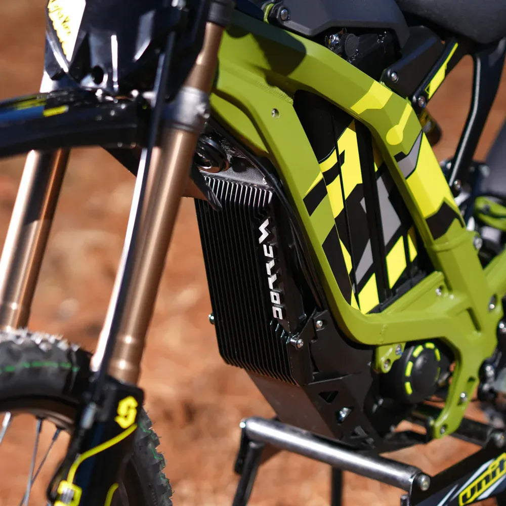 Close-up of a green and black surron 2025 lightbee x  electric bike with visible branding on a blurred background