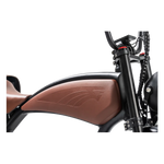 Close-up of a motorcycle's brown seat and black frame on a white background