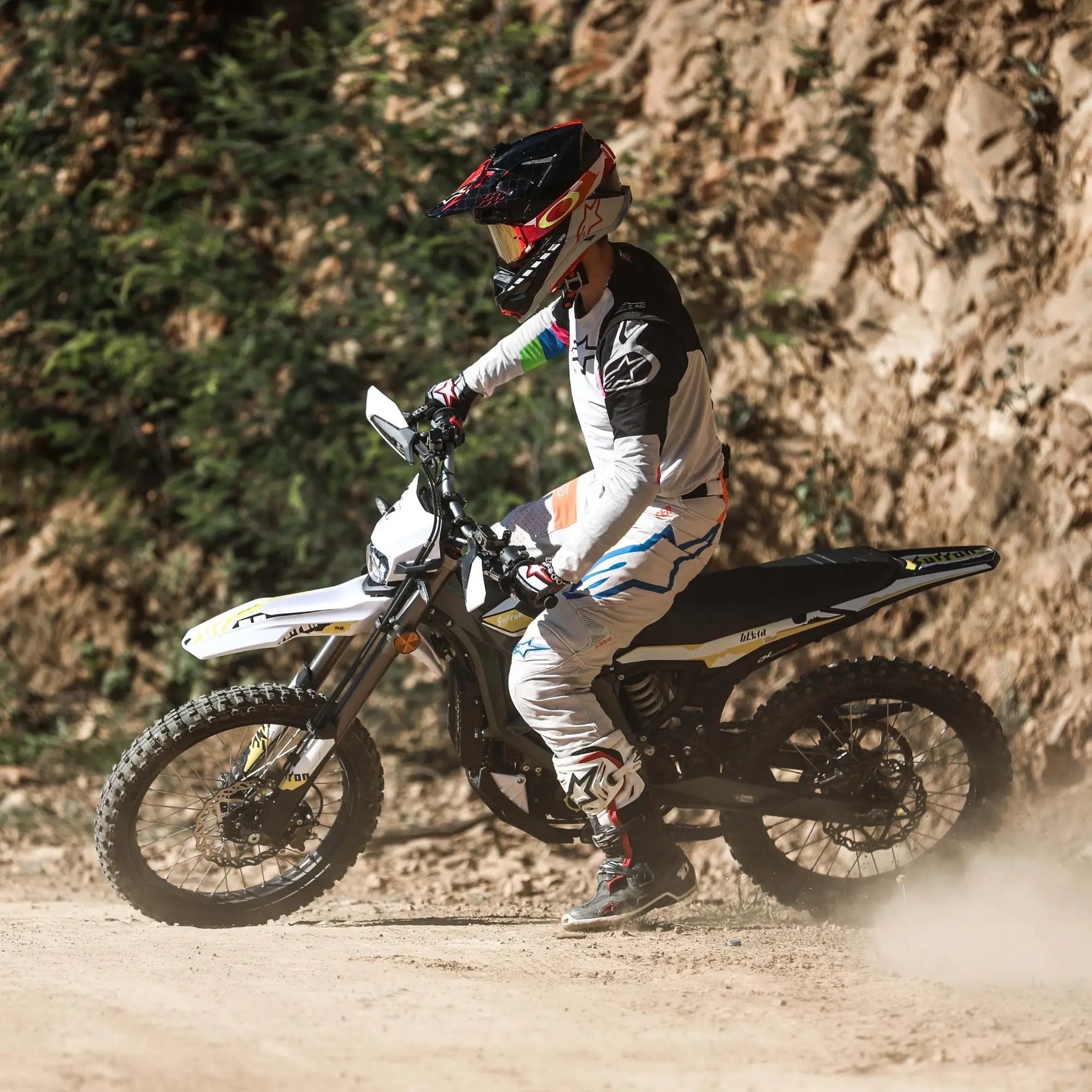 Person riding a surron ultra bee dirt bike on a rocky trail